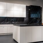 Contemporary kitchen interior design with empty white and black furniture in modern stylish apartment