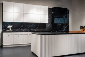 Contemporary kitchen interior design with empty white and black furniture in modern stylish apartment