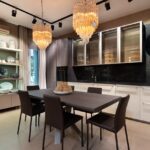 Stylish interior of modern kitchen with crystal chandeliers and wooden furniture